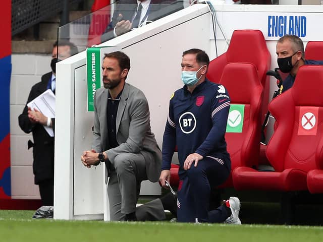 England's manager Gareth Southgate (L) and  Steve Holland, Assistant Coach of England (R) 'take a knee' ahead of the international friendly football match between England and Romania at the Riverside Stadium in Middlesbrough (Photo by SCOTT HEPPELL/POOL/AFP via Getty Images)