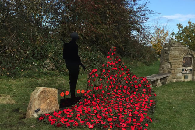 Silent soldier and hand made poppies at the Kings Clipsrone Remembrance monument - Picture: David Smith