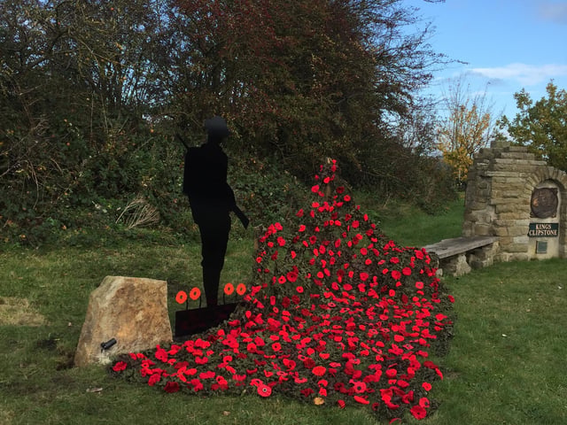 Silent soldier and hand made poppies at the Kings Clipsrone Remembrance monument - Picture: David Smith