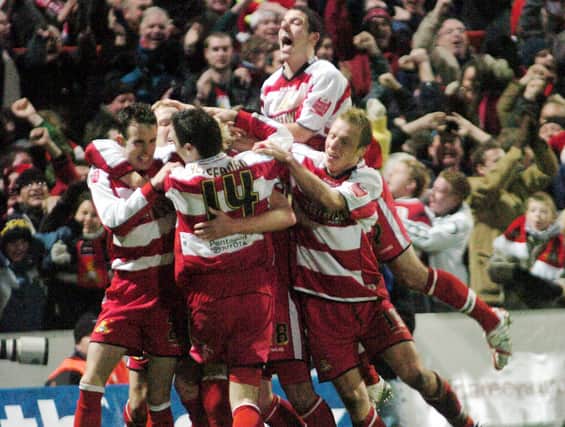 Doncaster Rovers celebrate after Paul Green put them ahead in extra time against Arsenal.