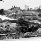 This is Hollins Bridge, Hollins Lane, on the road from Rivelin to the lower end of Stannington in the days before it became a traffic hazard. The pub, of course, is the Holly Bush. Hollins Farm is in the background.  Photo City Library Archives