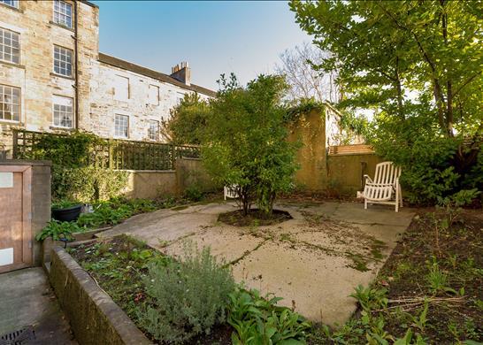 The property has a spacious garden for owners and guests to enjoy.