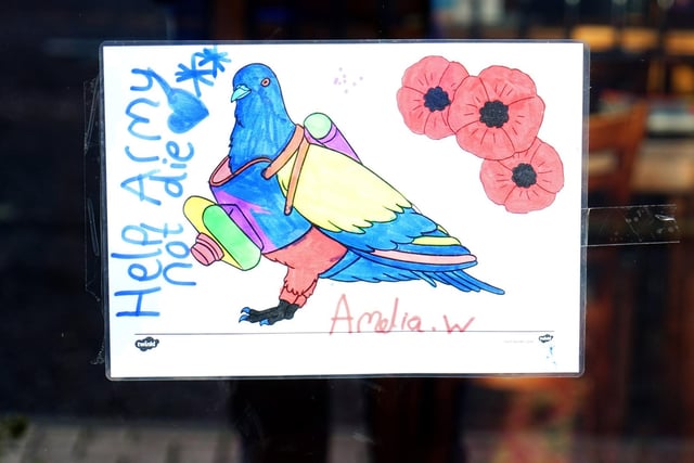 Amelia's efforts are displayed in the pub's window.