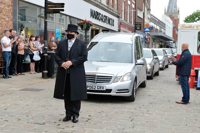 The funeral procession passes Don Hollingworth's old stall on Chesterfield Market.