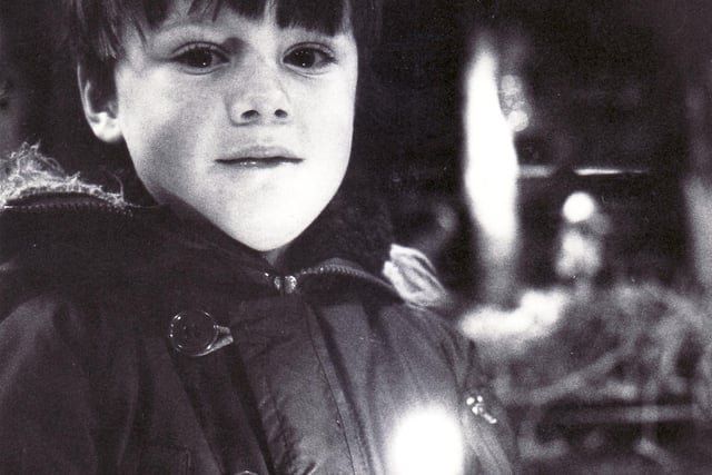 A young member of the congregation at the Christingle Service in St Mary's Church, Walkley in January 1984