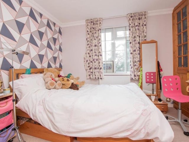 The second bedroom is busy and bright. Again it boasts lots of storage space.