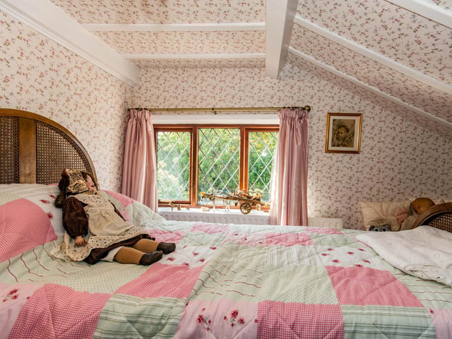 This bedroom has sloped ceilings.