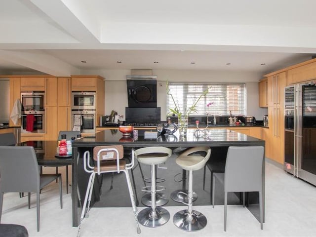 An island in the middle of the kitchen is perfect for casual dining. The room also boasts all the modern amenities and appliances that you need.