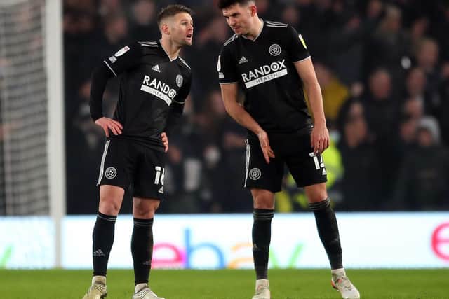 Oliver Norwood and John Egan in conversation during Sheffield United's defeat at Pride Park: Simon Bellis / Sportimage