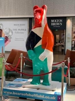 Pieces. The design was created by artist Nicolas Burrows who wanted to bring movement into the static Bear sculpture by adding wild and wonky shapes in bright, overlapping colours.