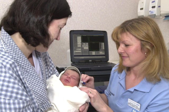 Baby Nesan was given a special hearing test that was new in 2002 but now commonplace for all babies, all new babies will be given. Seen LtoR are,  Mum Patricia Glynn,  Baby Nesan Conor, and Kate Pinhoro a new born baby screener