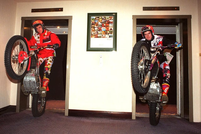 Motorcyclists Dougie Lampkin (right) and Martin Crosswait are shown checking in at the Sheffield Grosvenor Hotel, on Charter Square, ready for the 1998 Pace European Indoor Motorcycle Trials at Sheffield Arena