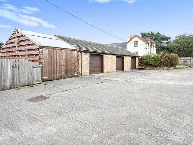 The exterior buildings include this triple garage. It has planning consent to be converted into a dwelling if required.