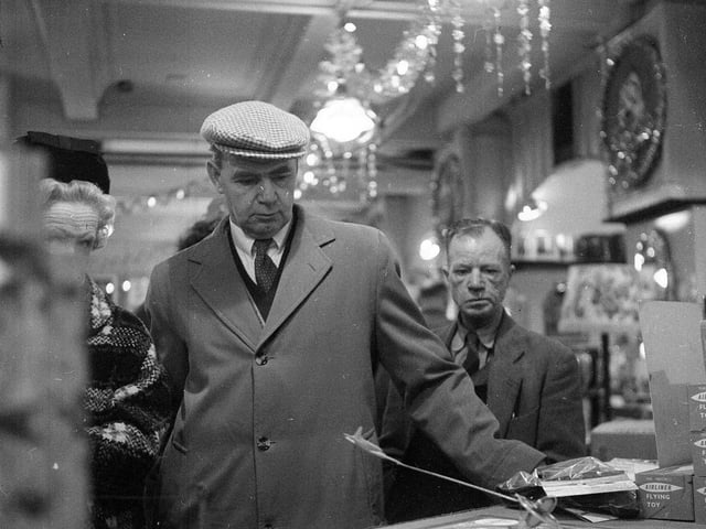 Two men 'enjoying' their Christmas shopping at Edinburgh's Expressions department store in 1962.