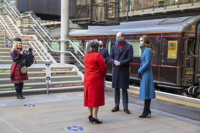 The Duke and Duchess of Cambridge are met by Deputy Lord Lieutenant Sandra Cumming (second left) and piper Louise Marshall (left) as they arrive by train at Edinburgh Waverley Station on the second day of a three-day tour across the country.