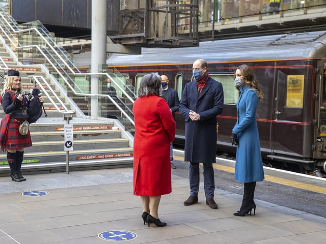 The Duke and Duchess of Cambridge are met by Deputy Lord Lieutenant Sandra Cumming (second left) and piper Louise Marshall (left) as they arrive by train at Edinburgh Waverley Station on the second day of a three-day tour across the country.