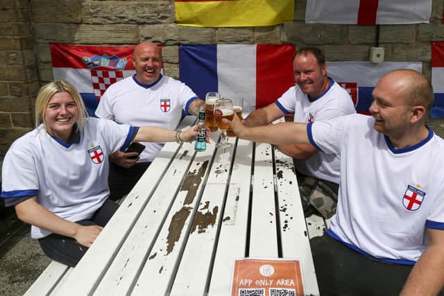 England football fans (left to right) Alisia Shaw, 18, Chris Shaw, 40, Sean Foster, 40, and Rory Hibbert, 25, ahead of the England vs Germany game at the Big Tree