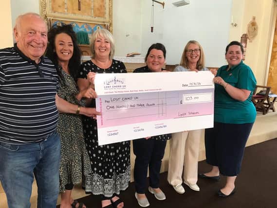 Lynda, third from left, presents her cheque to Lost Chord UK