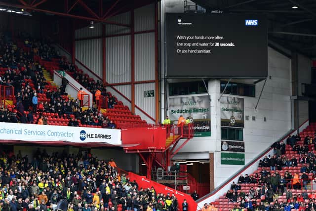 A general view of the big screen with an announcement from the NHS about hand washing during a Premier League match at Bramall Lane, Sheffield: Anthony Devlin/PA Wire.