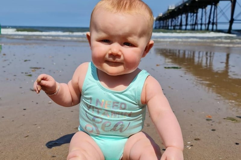 This tot has been to the beach.
