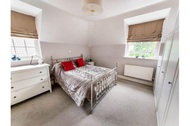 The master bedroom is spacious and light, with fitted wardrobes.