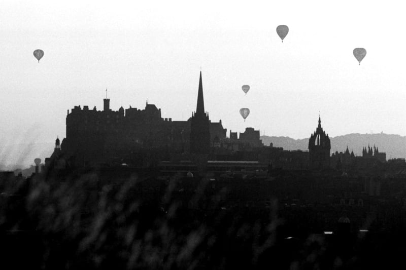 Hot air balloons rise from Holyrood Park silhouetted against the Edinburgh skyline in August 1984.
