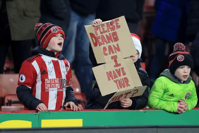 Young Sheffield United fans hold up a sign asking for Dean Henderson's shirt during a Premier League match at Bramall Lane, Sheffield: Mike Egerton/PA Wire.