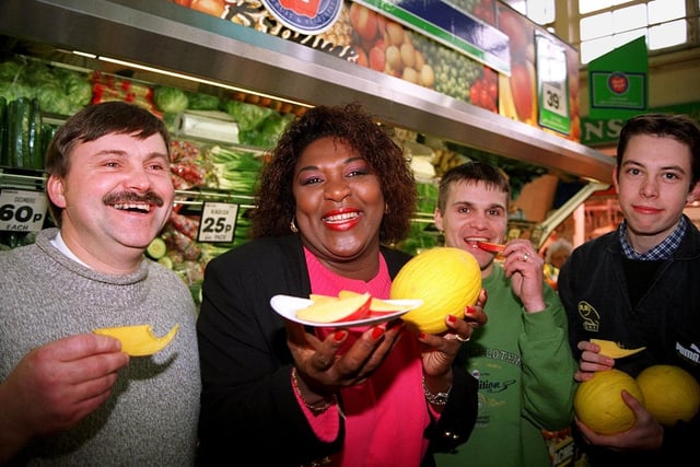 Rustie Lee hands out mango and melon at the Castle Market to support the campaign to save the independent greengrocer. Lto R, Martyn and Ian Bingham of Bingham greengrocer and Jason Gath, November 1996