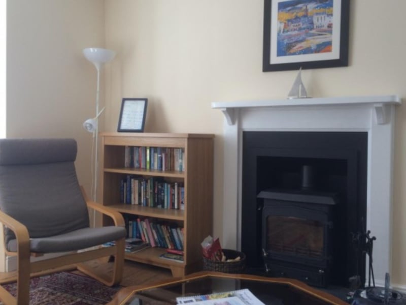 The comfy sitting room comes complete with board games, books and a wood burning stove.
