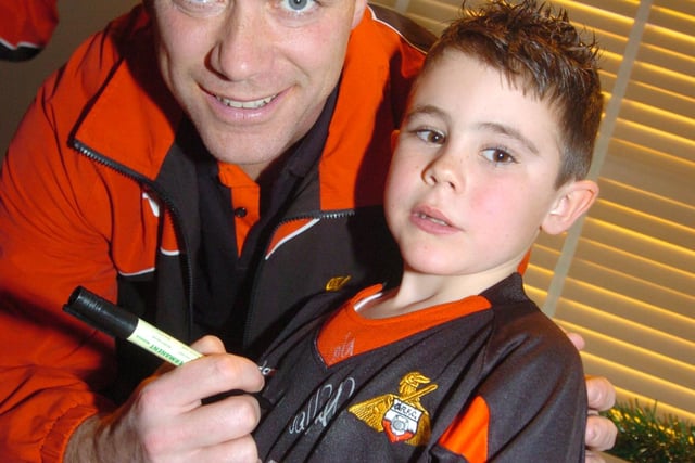Neil Sullivan meets six-year-old Charlie Graham of Bennetthorpe at the Junior Rovers Christmas party in 2009