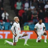 Players kneel down against racism before the UEFA EURO 2020 Group D football match between England and Scotland at Wembley Stadium in London on June 18, 2021. (Photo by JUSTIN TALLIS / POOL / AFP) (Photo by JUSTIN TALLIS/POOL/AFP via Getty Images)