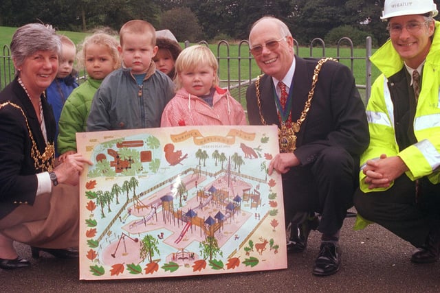 The mayor Councillor Trevor Bagshaw and Mayoress Margaret Bagshaw and Paul Baxter, managing director of  Wheatley construction, who are the contractors for the job with children from Maypole nursery with plans showing how the play area will look back in 1999