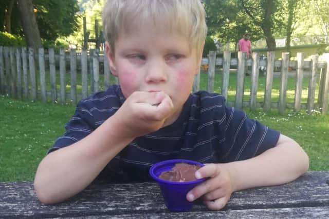Lucas Croxall tucking into a Cadbury Pots of Joy dessert. The nine-year-old from Stannington, Sheffield, has Lowe sydrome and the dessert is one of only two things he will eat, and his mum is desperate as she cannot find any more of the product