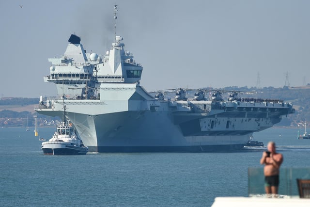 People watch on as HMS Queen Elizabeth departs. Picture: Finnbarr Webster/Getty Images