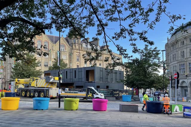 Shipping containers being unloaded in Fargate, Sheffield city centre - the manager of the popular Rose Garden Cafe in Graves Park says they would be an ideal temporary replacement for the closed building