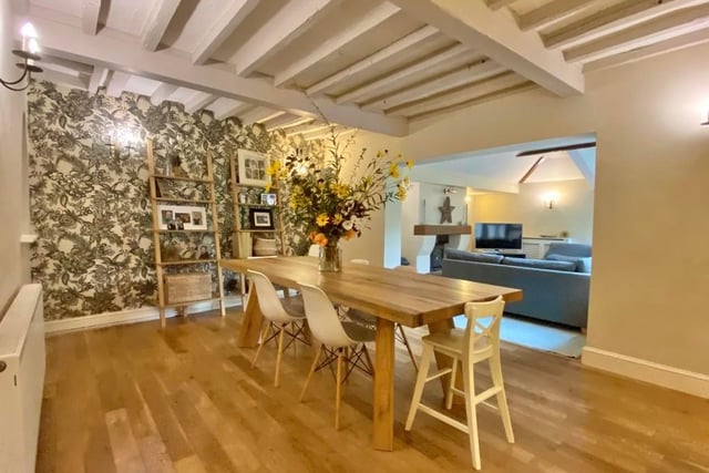 The first room we look at is the dining room. With exposed beams, oak flooring, wall lights and an open archway window to the family room, there is ample space for a large dining table.