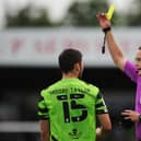 NAILSWORTH, ENGLAND - AUGUST 07: Match Referee James Bell shows a yellow card to Jordan Moore-Taylor of Forest Green Rovers during the Sky Bet League Two match between Forest Green Rovers and Sutton United at The Fully Charged New Lawn on August 07, 2021 in Nailsworth, England. (Photo by Alex Burstow/Getty Images)