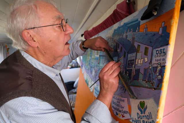 Artist Joe Scarborough working on his latest projects on his boat in Sheffield Canal Basin.