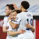 Scotland's Ryan Fraser (C) is congratulated for his goal by teammates Che Adams (R) and Andrew Robertson during the 2022 FIFA World Cup qualifier group F football match between Israel and Scotland at Bloomfield stadium in Tel Aviv (Photo by JACK GUEZ/AFP via Getty Images)