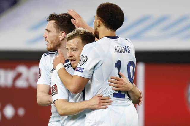 Scotland's Ryan Fraser (C) is congratulated for his goal by teammates Che Adams (R) and Andrew Robertson during the 2022 FIFA World Cup qualifier group F football match between Israel and Scotland at Bloomfield stadium in Tel Aviv (Photo by JACK GUEZ/AFP via Getty Images)