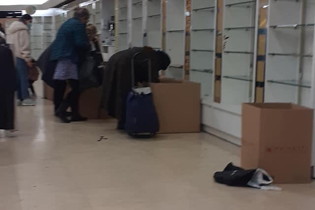 Shoppers scour boxes for bargains on the last day of trading at Debenhams on The Moor in Sheffield