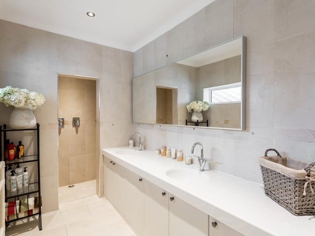 The master bedroom en-suite has two sinks and a walk-in shower.