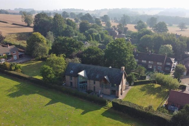 A spectacular aerial shot of the £1 million property. As you can see, to the side, there is a large lawn, bordered by flowerbeds and mature trees.The south-facing sun-terrace is also perfect for entertaining.