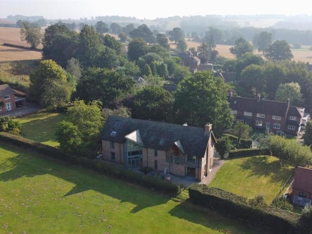 A spectacular aerial shot of the £1 million property. As you can see, to the side, there is a large lawn, bordered by flowerbeds and mature trees.The south-facing sun-terrace is also perfect for entertaining.