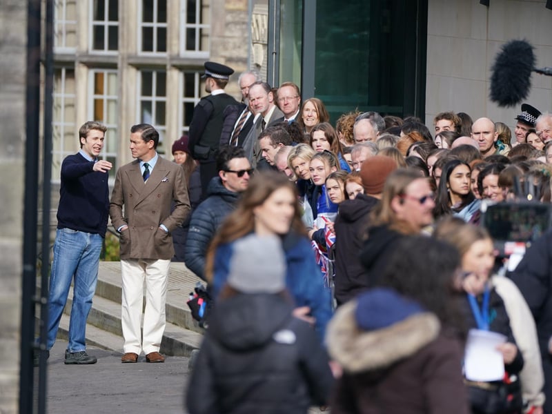 Ed McVey, playing the part of Prince William and Dominic West playing the part of Prince of Wales as they film scenes for the next season of The Crown in St Andrews, Scotland.