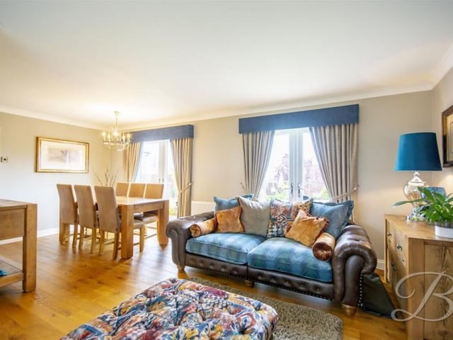 A dual aspect room, featuring a window to the front elevations and two 'French doors' to the rear allowing for natural lighting.