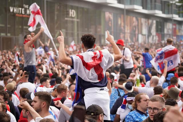England fans cheer on their team outside Wembley Stadium ahead of the UEFA EURO 2020 final.