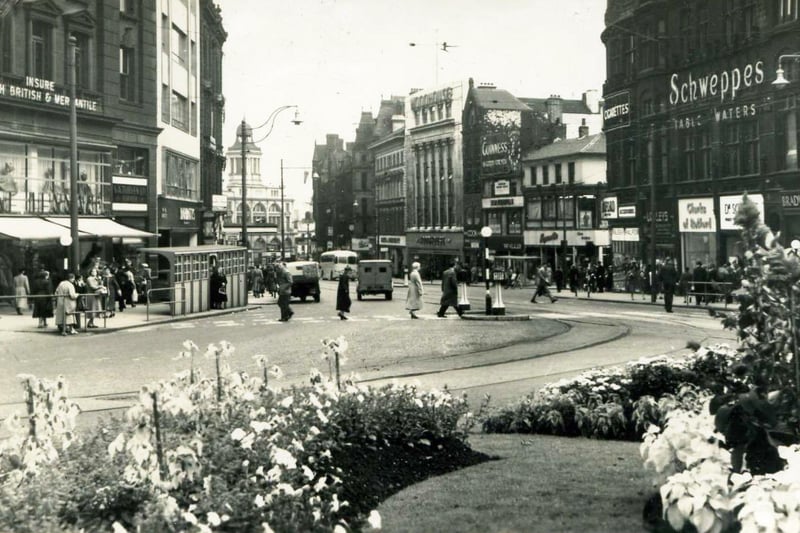 An old  view of a Fargate busy with traffic and shoppers