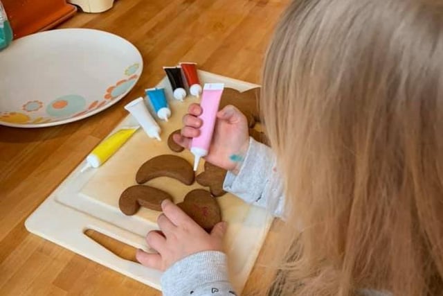 Four-year-old Morgan is learning home economics by following BBC Good Food's recipe for gingerbread people.
