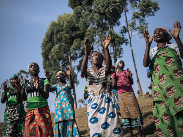 Displaced women from the Bafuliru community pray near the internally displaced persons camp of Bijombo, South Kivu Province, eastern Democratic Republic of Congo.